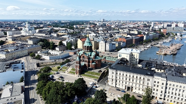 Aerial view of Uspenski Cathedral surrounded by historic buildings the harbor and the cityscape of Helsinki Uusimaa Finland. Aerial view of Uspenski Cathedral surrounded by historic buildings the harbor and the cityscape of Helsinki Uusimaa Finland.