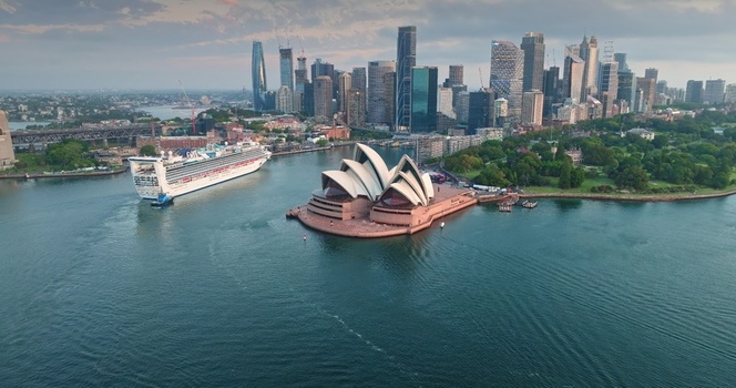 Aerial view of the Sydney Opera House with a cruise ship in the harbor and the modern skyline in the background in Sydney New South Wales Australia. Aerial view of the Sydney Opera House with a cruise ship in the harbor and the modern skyline in the background in Sydney New South Wales Australia.