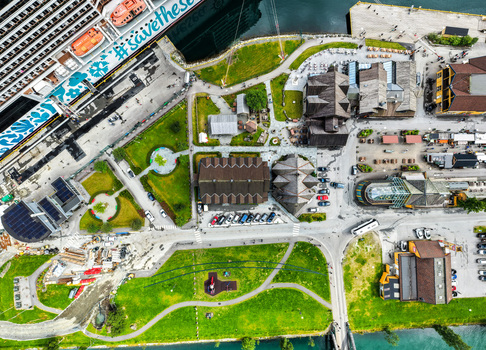 Flam Vestland Norway 18 June 2026 Aerial view of the port area in Flam featuring a large cruise ship docked traditional wooden architecture green park spaces and surrounding roads. Flam Vestland Norway 18 June 2026 Aerial view of the port area in Flam featuring a large cruise ship docked traditional wooden architecture green park spaces and surrounding roads.