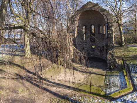 Aerial view of the Valkhof ruins standing as a stark monument against the winter sky framed by bare trees and a delicate wrought iron fence Nijmegen Gelderland Netherlands. Aerial view of the Valkhof ruins standing as a stark monument against the winter sky framed by bare trees and a delicate wrought iron fence Nijmegen Gelderland Netherlands.
