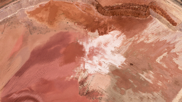 Aerial view of industrial salt production site with vibrant red and white earth patterns and textured terrain in Kalbarri Western Australia Australia. Aerial view of industrial salt production site with vibrant red and white earth patterns and textured terrain in Kalbarri Western Australia Australia.