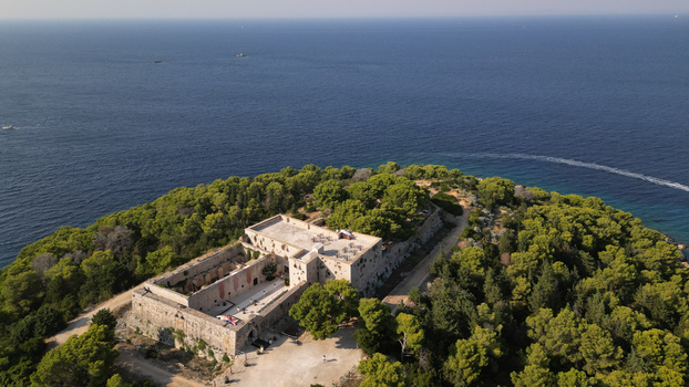 Aerial view of Fort George a historic stone fortress on a lush green peninsula overlooking the Adriatic Sea Vis Splitsko dalmatinska Croatia. Aerial view of Fort George a historic stone fortress on a lush green peninsula overlooking the Adriatic Sea Vis Splitsko dalmatinska Croatia.