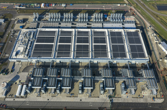 Aerial view of the Google data center featuring solar panels on the roof and industrial cooling systems in Winschoten Groningen Netherlands.