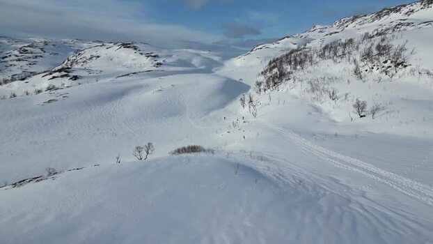 Aerial view of snowy hills and mountains of Kvaloya Norway.