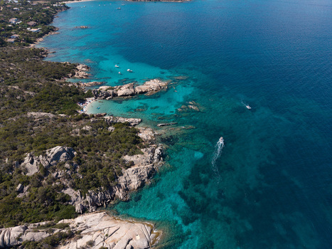 Aerial view of the turquoise waters and rocky coastline of San Teodoro with boats sailing in the Mediterranean Sea San Teodoro Sardegna Italy.