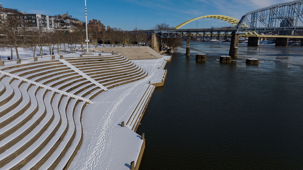 Aerial view of the snow covered terraced steps of Smale Riverfront Park along the Ohio River with bridges in the background Cincinnati Ohio United States. Aerial view of the snow covered terraced steps of Smale Riverfront Park along the Ohio River with bridges in the background Cincinnati Ohio United States.