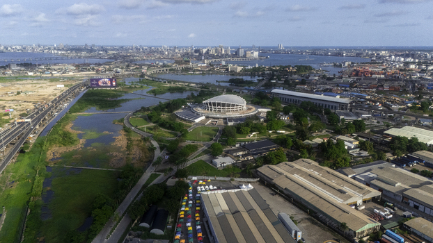 Aerial view of the Wole Soyinka Centre for Culture and Creative Arts National Theatre Nigeria surrounded by greenery and the urban skyline Lagos Lagos Nigeria. Aerial view of the Wole Soyinka Centre for Culture and Creative Arts National Theatre Nigeria surrounded by greenery and the urban skyline Lagos Lagos Nigeria.