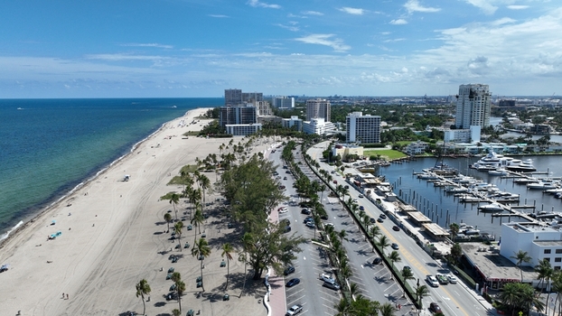 Aerial view of bright sands meet the turquoise ocean and modern architecture in a vibrant coastal metropolis Fort Lauderdale Florida United States.