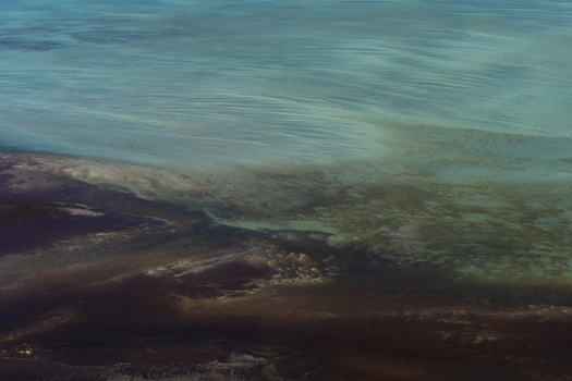 Aerial view of intricate tidal ocean patterns and dark sandbanks in the turquoise waters of the Shire of Shark Bay Western Australia Australia. Aerial view of intricate tidal ocean patterns and dark sandbanks in the turquoise waters of the Shire of Shark Bay Western Australia Australia.