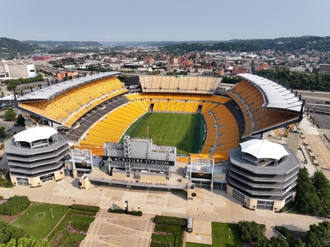 Pittsburgh Pennsylvania United States 26 July 2026 Aerial view of Acrisure Stadium with its yellow seating green football field and surrounding urban landscape.