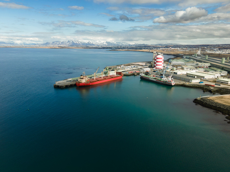 Hafnarfjordur Iceland 17 April 2026 Aerial view of the port featuring large cargo ships docked at the industrial pier with snow capped mountains in the distance. Hafnarfjordur Iceland 17 April 2026 Aerial view of the port featuring large cargo ships docked at the industrial pier with snow capped mountains in the distance.