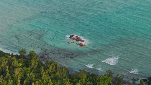 Aerial view of tropical coastline and rocky outcrop Seychelles.