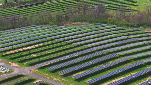 Aerial view of a solar farm with rows of photovoltaic panels United States. Aerial view of a solar farm with rows of photovoltaic panels United States.