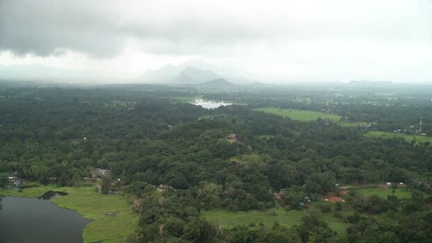 View of lush jungle and misty hills in Sigiriya Sri Lanka.