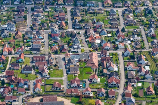 Aerial view of rooftops of quaint homes nestled amidst lush greenery and winding streets a tapestry of suburban charm Kintzheim Grand Est France.