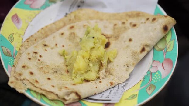 View of traditional flatbread and potato bhaji on a plate Bangladesh. View of traditional flatbread and potato bhaji on a plate Bangladesh.