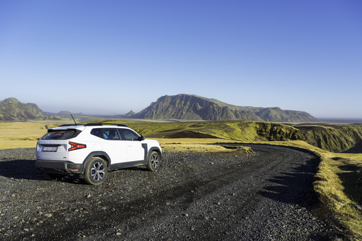 Katla Geopark Iceland 21 October 2025 View of a white SUV parked on a winding gravel road overlooking the vast volcanic landscape and rugged mountains under a clear blue sky. Katla Geopark Iceland 21 October 2025 View of a white SUV parked on a winding gravel road overlooking the vast volcanic landscape and rugged mountains under a clear blue sky.