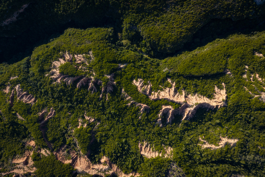 Aerial view of Gjipe Canyon featuring rugged rock formations and dense green vegetation in Iliaz Vlore County Albania.