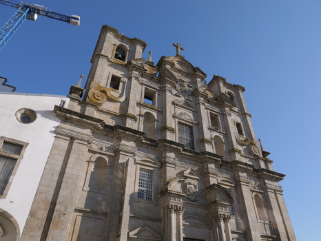 View of the ornate stone facade of the Igreja dos Congregados with its bell towers under a clear blue sky in Porto Porto District Portugal. View of the ornate stone facade of the Igreja dos Congregados with its bell towers under a clear blue sky in Porto Porto District Portugal.