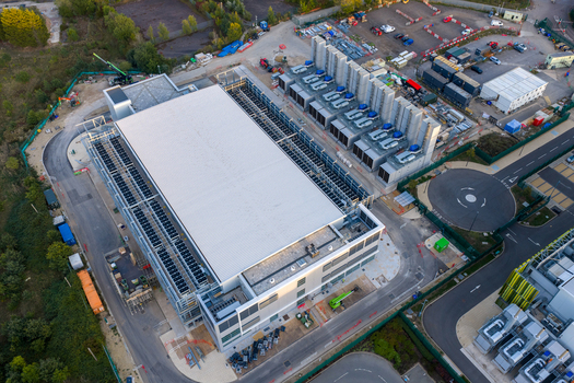 Aerial view of the Kao Data center facility featuring large industrial buildings cooling units and surrounding infrastructure in Harlow England United Kingdom. Aerial view of the Kao Data center facility featuring large industrial buildings cooling units and surrounding infrastructure in Harlow England United Kingdom.