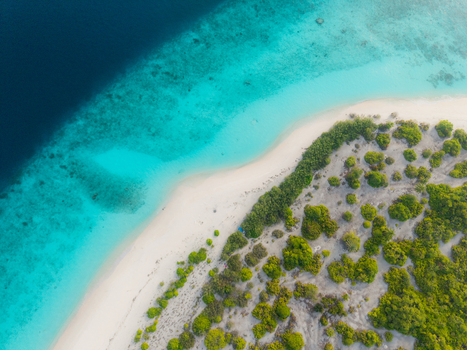 Aerial view of pristine white sands meeting vibrant turquoise shallows and deep sapphire ocean fringed by lush emerald foliage Hoarafushi Thiladhunmathee Uthuruburi Maldives. Aerial view of pristine white sands meeting vibrant turquoise shallows and deep sapphire ocean fringed by lush emerald foliage Hoarafushi Thiladhunmathee Uthuruburi Maldives.