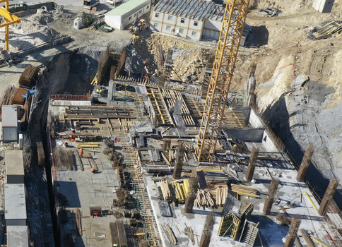 Aerial view of a large construction site with foundation rebar workers and a yellow crane in Avcilar Istanbul Turkiye. Aerial view of a large construction site with foundation rebar workers and a yellow crane in Avcilar Istanbul Turkiye.