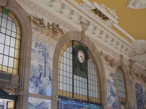 View of the intricate blue and white azulejo tile murals and the historic clock inside the Sao Bento Railway Station in Porto Porto District Portugal. View of the intricate blue and white azulejo tile murals and the historic clock inside the Sao Bento Railway Station in Porto Porto District Portugal.