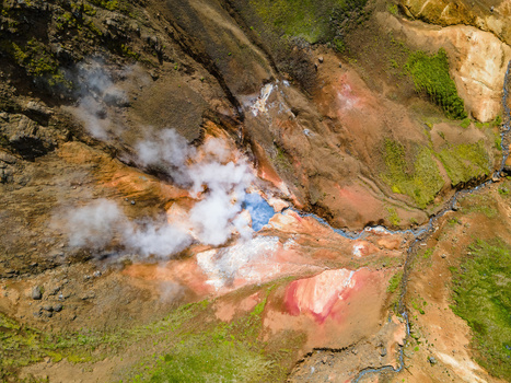 Aerial view of the geothermal area in Grensdalur featuring steam vents vibrant mineral deposits and rugged volcanic terrain in Sveitarfelagid Olfus Iceland. Aerial view of the geothermal area in Grensdalur featuring steam vents vibrant mineral deposits and rugged volcanic terrain in Sveitarfelagid Olfus Iceland.