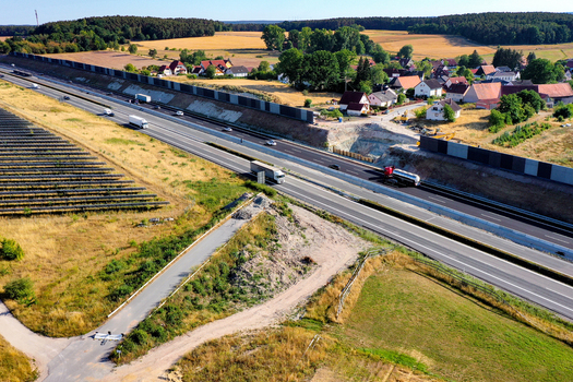 Nurnberg Germany 18 May 2024 Aerial view of the A73 highway with traffic noise protection walls and adjacent residential houses. Nurnberg Germany 18 May 2024 Aerial view of the A73 highway with traffic noise protection walls and adjacent residential houses.