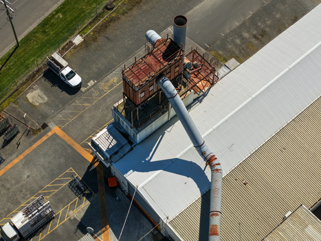Kilsyth Victoria Australia 20 September 2026 Aerial view of an industrial facility rooftop with a large ventilation system rusted pipes service trucks and corrugated metal roofing. Kilsyth Victoria Australia 20 September 2026 Aerial view of an industrial facility rooftop with a large ventilation system rusted pipes service trucks and corrugated metal roofing.
