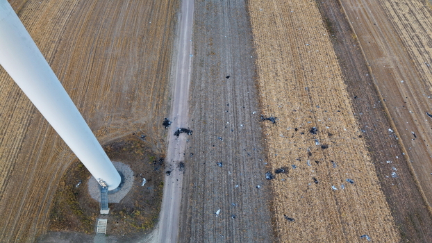 Aerial view of the aftermath of a wind turbine destruction with scattered debris across the agricultural fields in Vladimirovac Vojvodina Serbia.