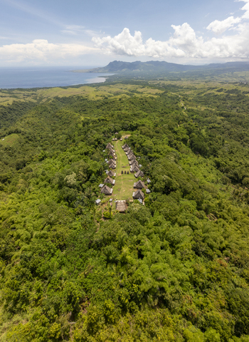 Aerial view of Kampung Adat Belaraghi a traditional village with thatched roof houses nestled in lush green hills overlooking the sea Kecamatan Aimere Nusa Tenggara Timur Indonesia. Aerial view of Kampung Adat Belaraghi a traditional village with thatched roof houses nestled in lush green hills overlooking the sea Kecamatan Aimere Nusa Tenggara Timur Indonesia.