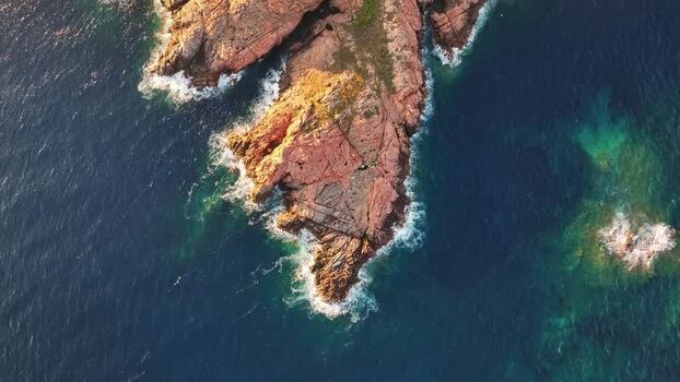 Aerial view of the rugged red granite cliffs of Costa Paradiso Italy. Aerial view of the rugged red granite cliffs of Costa Paradiso Italy.