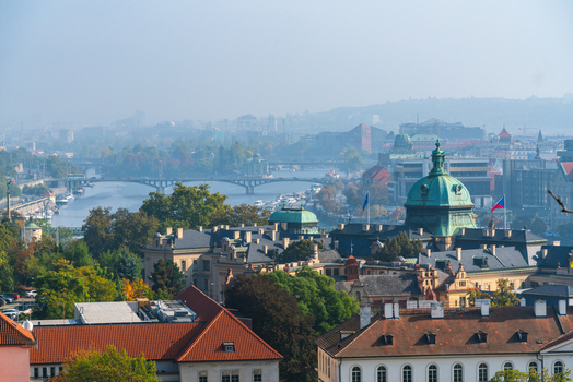 View of the Vltava River bridges and the historic architecture of the Strakova Academy with its prominent green dome in Prague Prague Czechia.