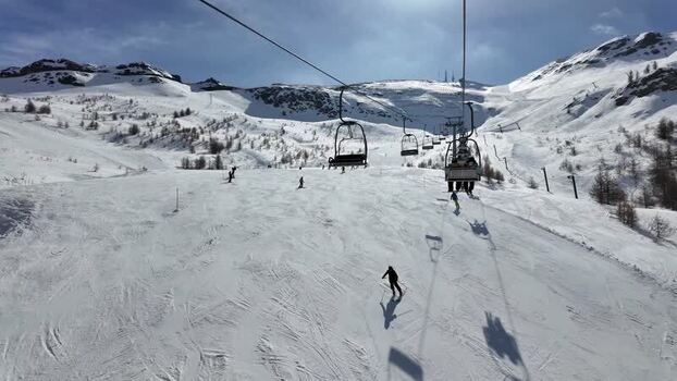 View of ski resort with chairlift and skiers Italy. View of ski resort with chairlift and skiers Italy.