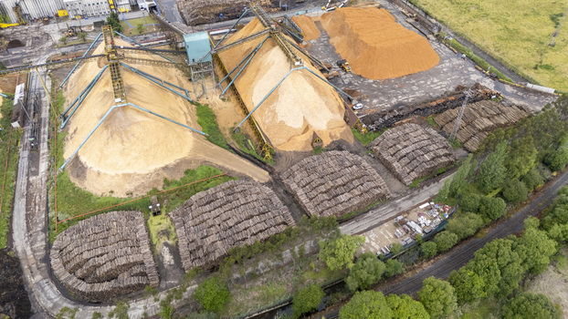 Aerial view of Biofabrica de Ence with large piles of wood chips and stacks of logs processed by industrial machinery in Pontevedra Pontevedra Spain. Aerial view of Biofabrica de Ence with large piles of wood chips and stacks of logs processed by industrial machinery in Pontevedra Pontevedra Spain.