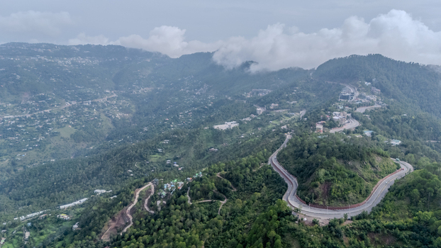 Aerial view of Islamabad Murree Expressway winding through the lush green mountains and dense forests of Lower Topa Punjab Pakistan. Aerial view of Islamabad Murree Expressway winding through the lush green mountains and dense forests of Lower Topa Punjab Pakistan.