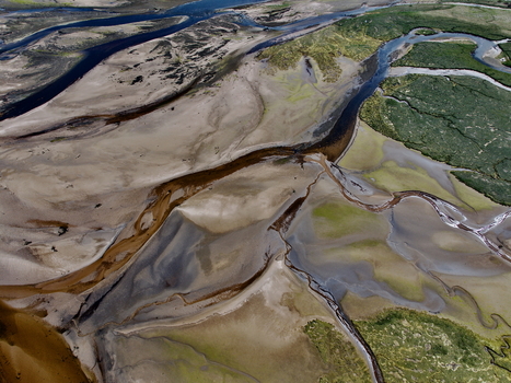 Aerial view of Findhorn Bay with winding water channels sandy banks and green marshland in Findhorn Scotland United Kingdom. Aerial view of Findhorn Bay with winding water channels sandy banks and green marshland in Findhorn Scotland United Kingdom.