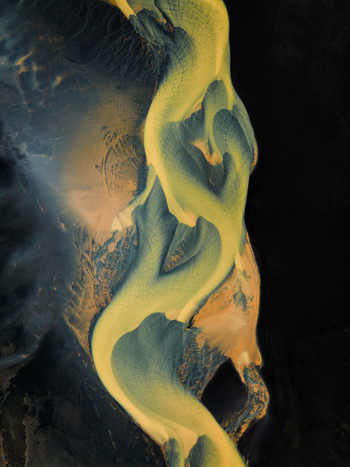 Aerial view of braided rivers carve through the stark landscape their golden sands contrasting with the dark volcanic earth Iceland. Aerial view of braided rivers carve through the stark landscape their golden sands contrasting with the dark volcanic earth Iceland.