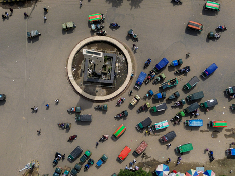 Rajshahi Rajshahi Division Bangladesh 26 September 2026 Aerial view of a busy roundabout with a central monument auto rickshaws motorcycles and pedestrians in the city. Rajshahi Rajshahi Division Bangladesh 26 September 2026 Aerial view of a busy roundabout with a central monument auto rickshaws motorcycles and pedestrians in the city.