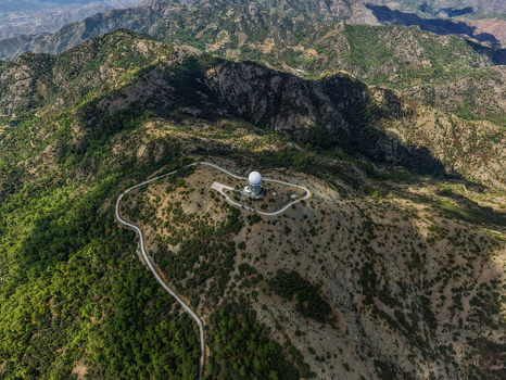 Aerial view of Kionia radar station on a mountain peak surrounded by rugged terrain dense forests and winding access roads Lazanias Lefkosia Cyprus. Aerial view of Kionia radar station on a mountain peak surrounded by rugged terrain dense forests and winding access roads Lazanias Lefkosia Cyprus.