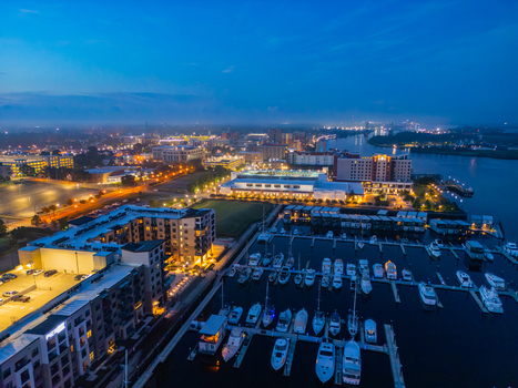 Aerial view of Riverfront Park and the marina with boats docked along the Cape Fear River at dusk in Wilmington North Carolina United States.