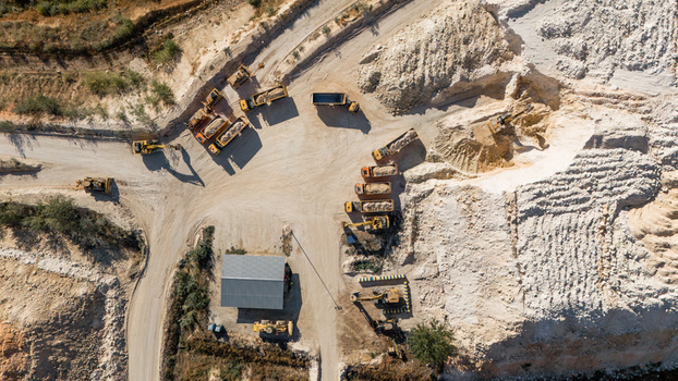 Aerial view of the Besenovo quarry with heavy machinery excavators and dump trucks operating in the industrial mining site in Besenovo Vojvodina Serbia. Aerial view of the Besenovo quarry with heavy machinery excavators and dump trucks operating in the industrial mining site in Besenovo Vojvodina Serbia.