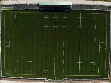 Stafford United Kingdom 23 April 2020 Aerial view of the Stafford Rugby Union Football Club pitch featuring green artificial turf with white markings and a spectator stand. Stafford United Kingdom 23 April 2020 Aerial view of the Stafford Rugby Union Football Club pitch featuring green artificial turf with white markings and a spectator stand.