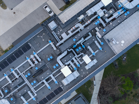 Aerial view of the AI data center cooling system on a modern building roof with ventilation ducts and solar panels in Krakow Lesser Poland Voivode Poland. Aerial view of the AI data center cooling system on a modern building roof with ventilation ducts and solar panels in Krakow Lesser Poland Voivode Poland.