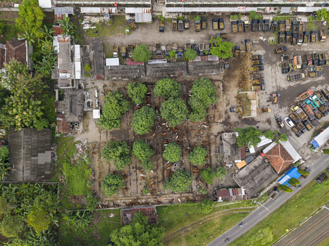 Aerial view of Animal Market Prambanan with trucks parked in rows green trees and traditional market structures in Kecamatan Prambanan Jawa Tengah Indonesia. Aerial view of Animal Market Prambanan with trucks parked in rows green trees and traditional market structures in Kecamatan Prambanan Jawa Tengah Indonesia.
