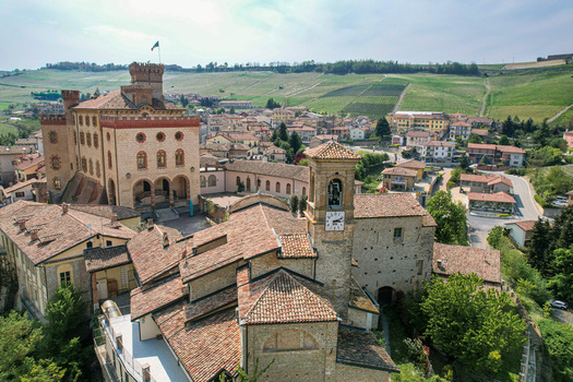 Aerial view of the historic Castello Falletti and the terracotta rooftops of the village surrounded by rolling vineyards Barolo Piedmont Italy. Aerial view of the historic Castello Falletti and the terracotta rooftops of the village surrounded by rolling vineyards Barolo Piedmont Italy.
