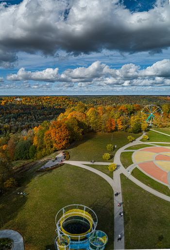 Aerial view of Sigulda park with a ferris wheel colorful autumn trees winding pathways and a cloudy blue sky in Sigulda Sigulda Municipality Latvia. Aerial view of Sigulda park with a ferris wheel colorful autumn trees winding pathways and a cloudy blue sky in Sigulda Sigulda Municipality Latvia.