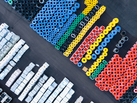 Aerial view of colorful industrial pipe rolls neatly arranged in a manufacturing storage yard in Jelgava Latvia. Aerial view of colorful industrial pipe rolls neatly arranged in a manufacturing storage yard in Jelgava Latvia.