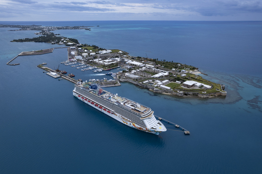 Royal Dockyard Bermuda 16 December 2022 Aerial view of the Norwegian Getaway cruise ship docked at the historic Royal Dockyard surrounded by turquoise waters. Royal Dockyard Bermuda 16 December 2022 Aerial view of the Norwegian Getaway cruise ship docked at the historic Royal Dockyard surrounded by turquoise waters.